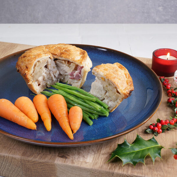 turkey, bacon & stuffing individual pie cut with carrots and green beans